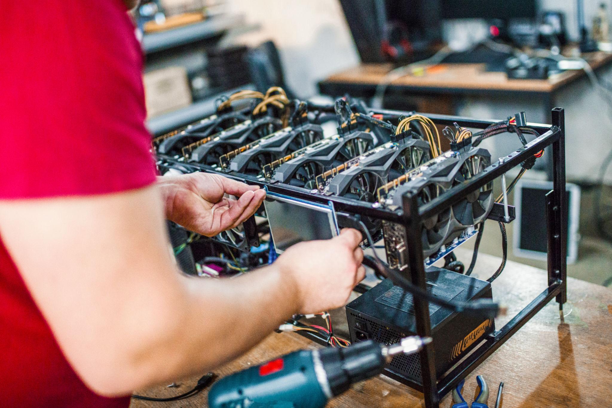 Technician carrying out PC repair work at a computer workstation